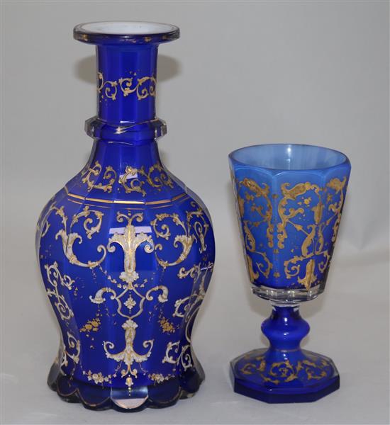 A Bohemian gilt decorated and white enamelled blue glass decanter and matching goblet, late 19th century, 26.5cm and 17.3cm, manufactur
